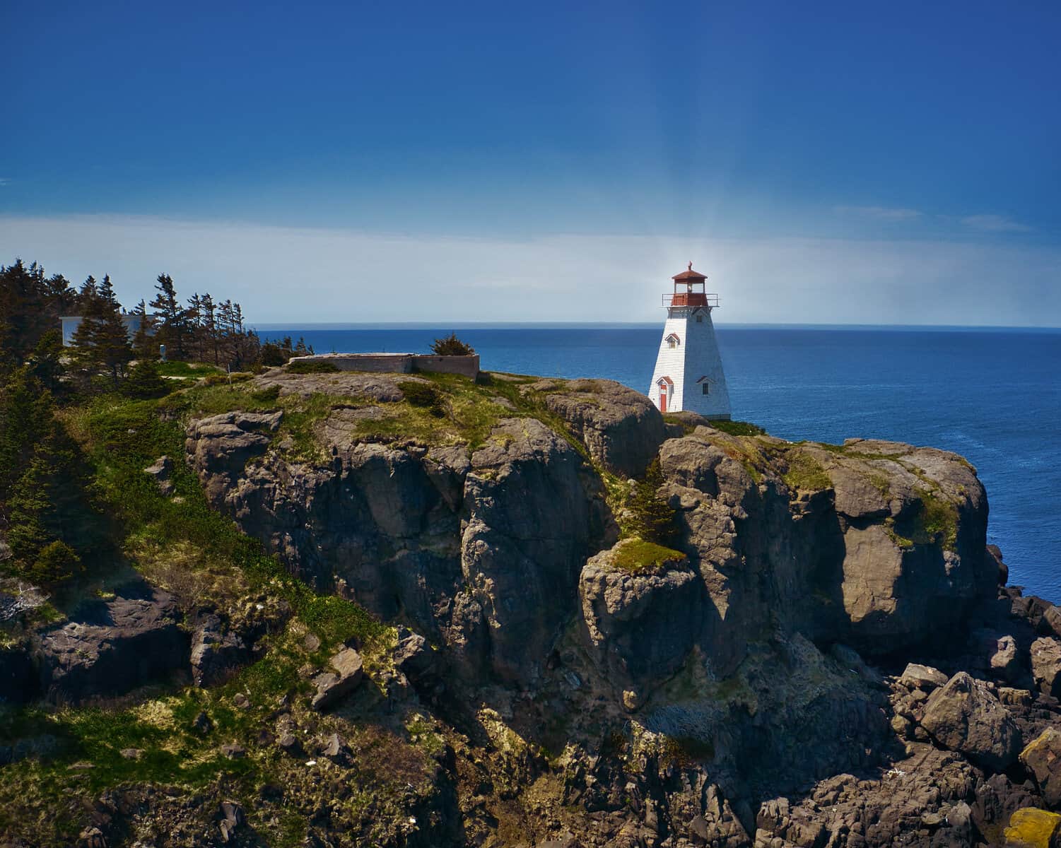 Aerial photograph of a lighthouse on a rocky Nova Scotia headland