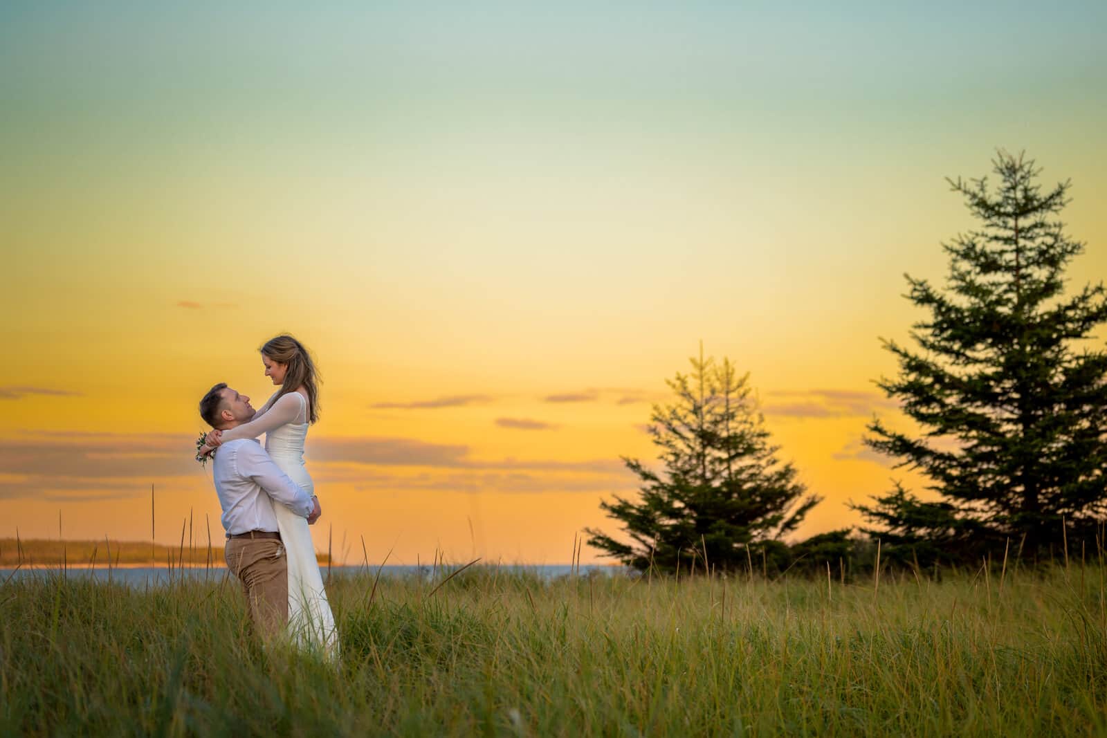 Engaged couple walking along the coast at dusk, Nova Scotia