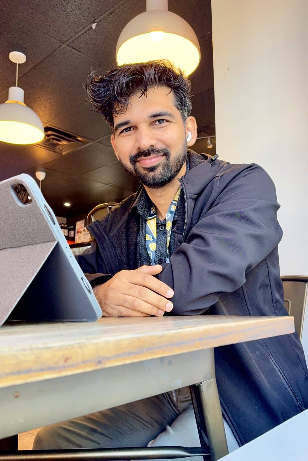 Ravin, Halifax photographer, seated at a café table