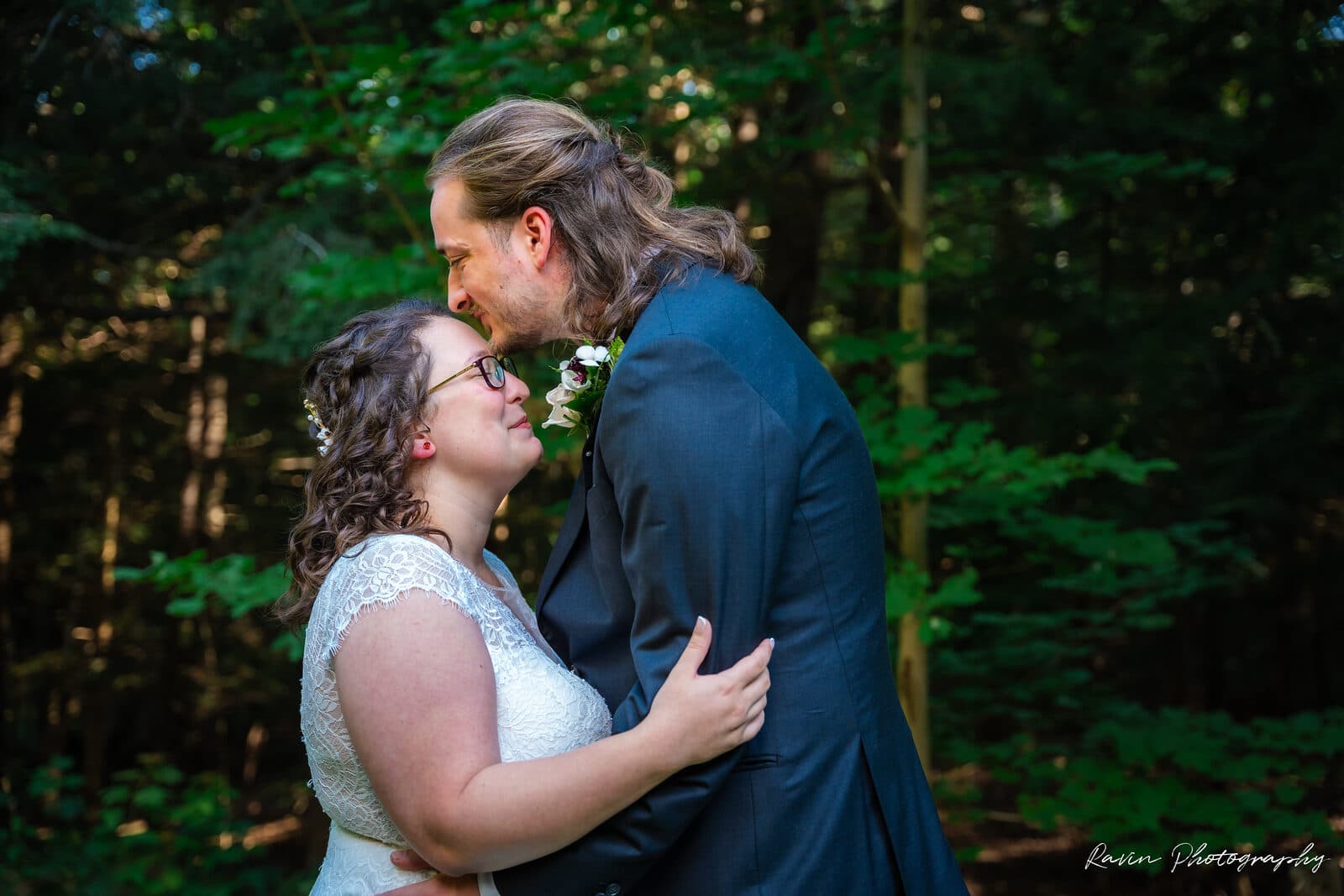 Newlyweds embracing in the woods after their Nova Scotia ceremony
