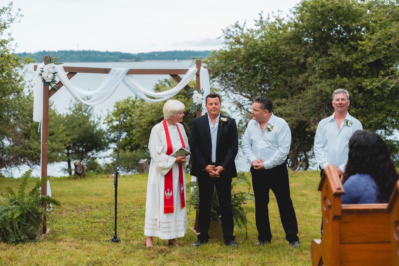 Outdoor wedding ceremony under an arch in Nova Scotia