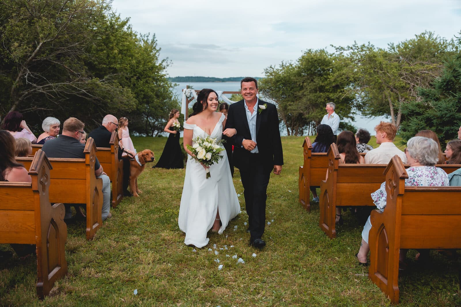 Wedding ceremony with guests seated outdoors, Nova Scotia