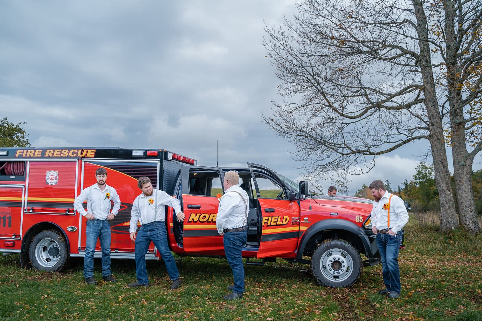 Wedding party celebrating beside a fire truck in Nova Scotia