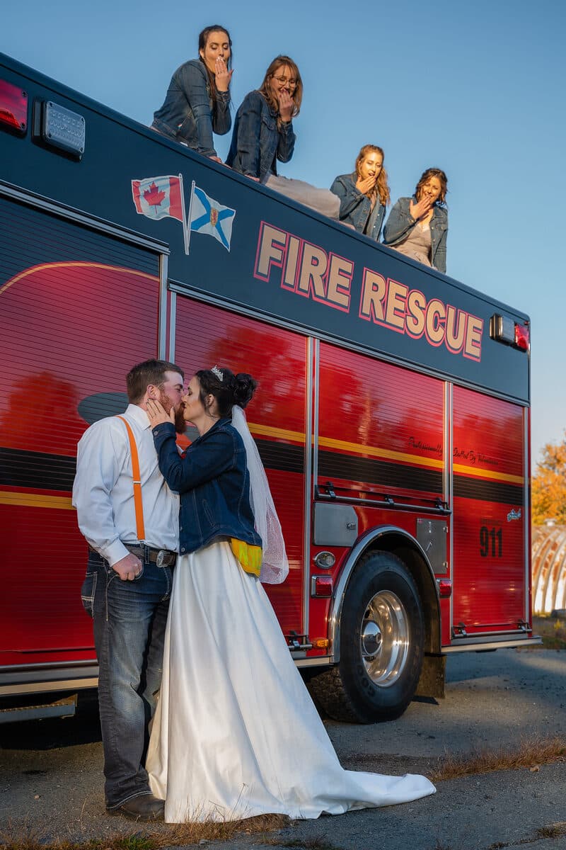Bride photographed with a fire truck send-off at a Nova Scotia wedding