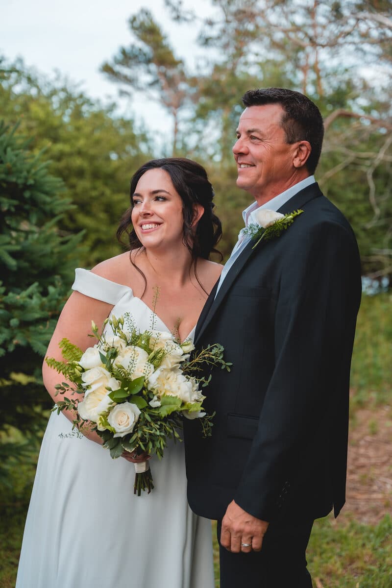 Bride and groom portrait among pine trees in Nova Scotia