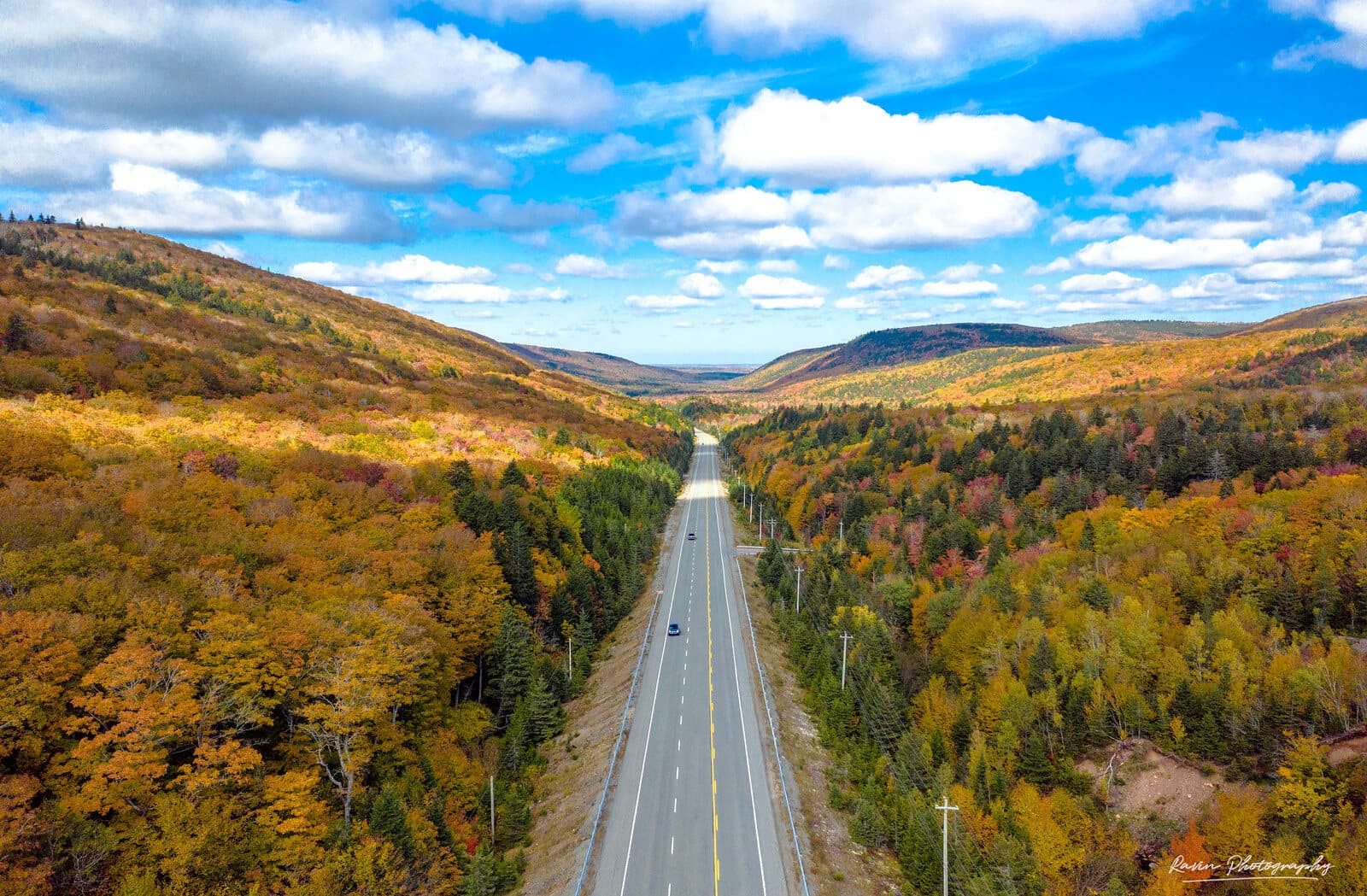 Aerial view of the Cabot Trail winding through autumn hills, Cape Breton, Nova Scotia