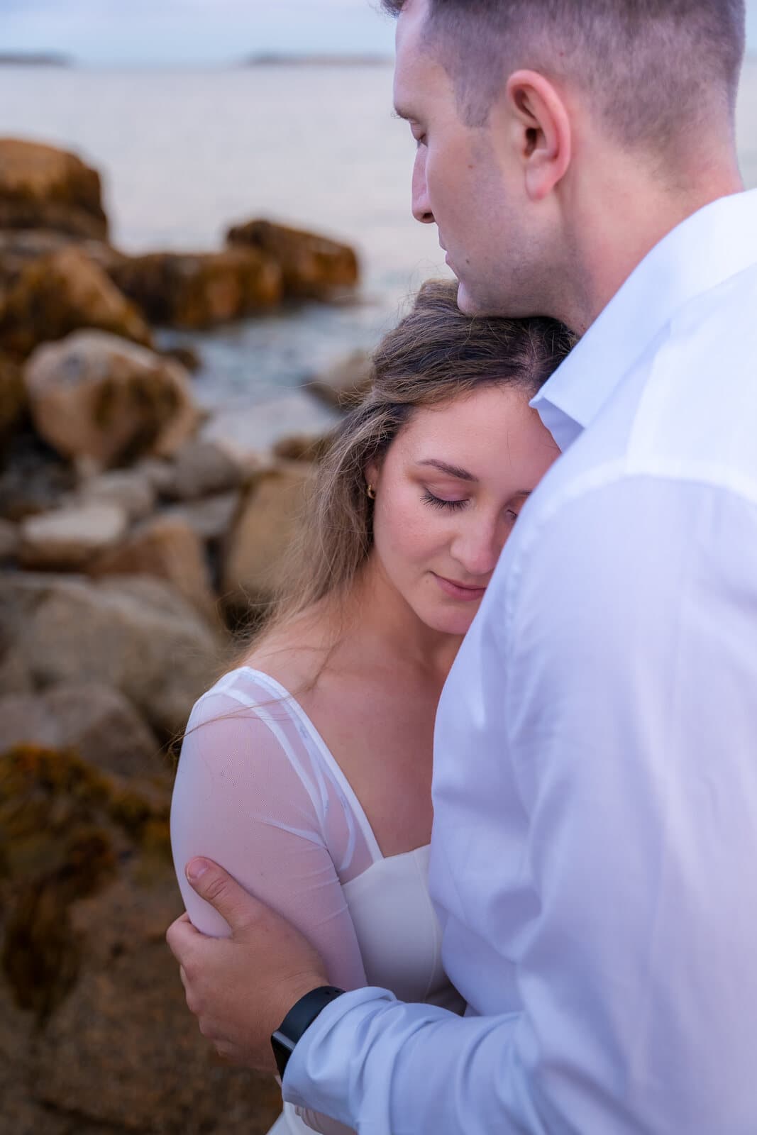 Close engagement portrait on the rocks at golden hour, Nova Scotia