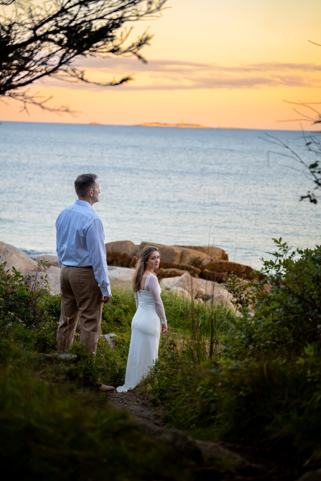 Engagement portrait on a rocky Nova Scotia shoreline at sunset