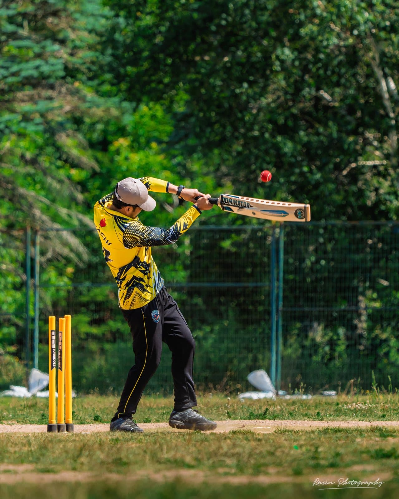 Cricket batter mid-swing, ball in flight, Halifax match