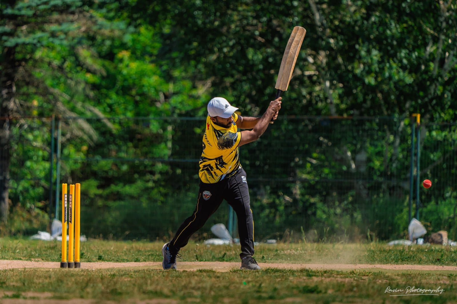 Cricket batter follow-through, bat blurred, Halifax match